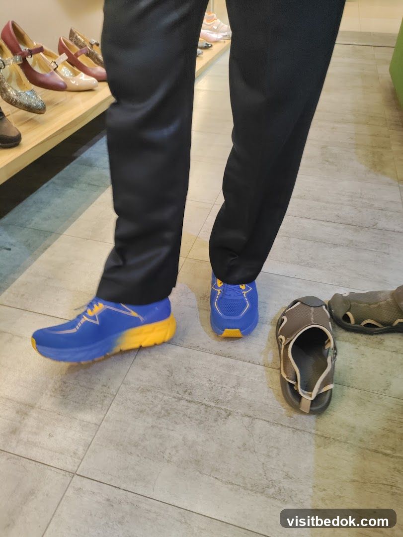 Person trying on blue and yellow sneakers