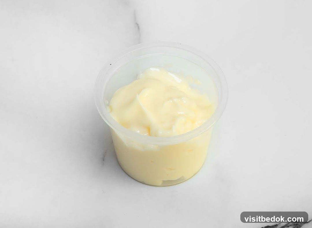 Mayonnaise in a clear plastic cup