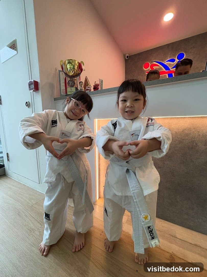 Two young children in Taekwondo uniforms