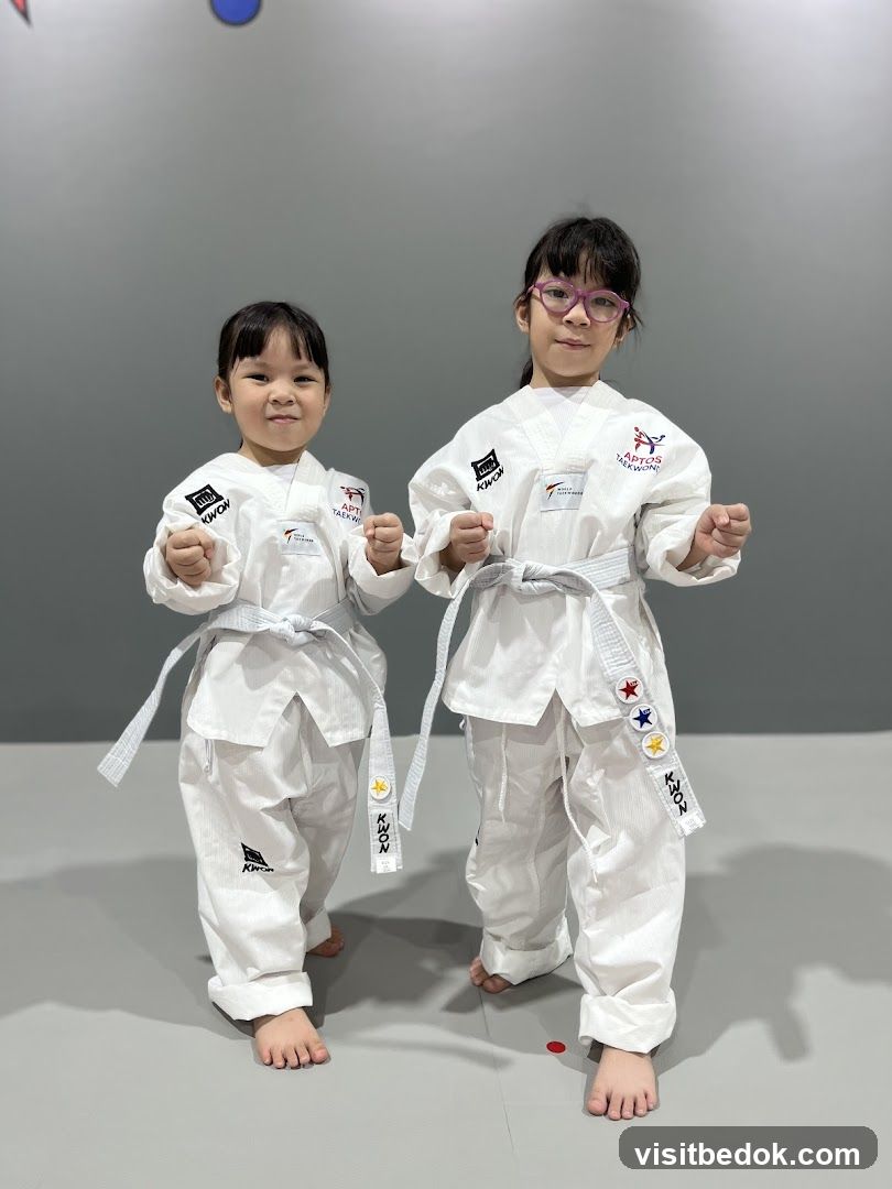 Two children in Taekwondo uniforms