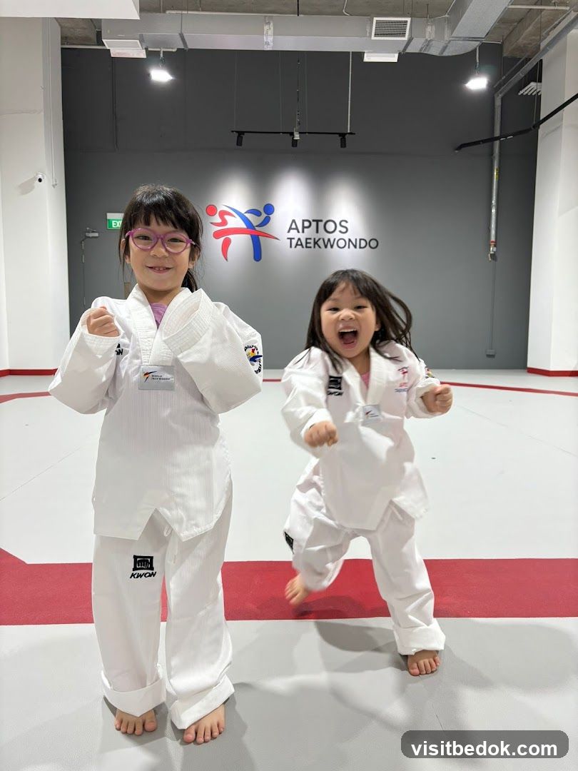 Two children in Taekwondo uniforms
