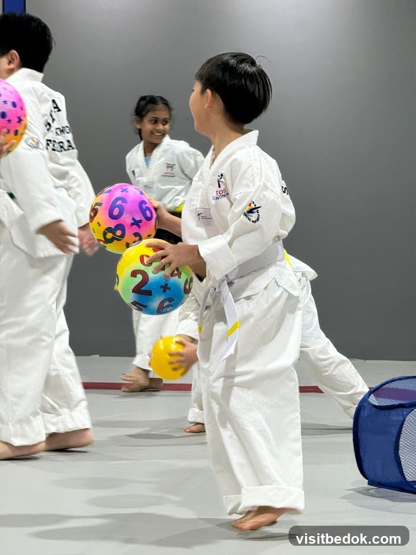 Children in Taekwondo Uniforms Playing with Balls