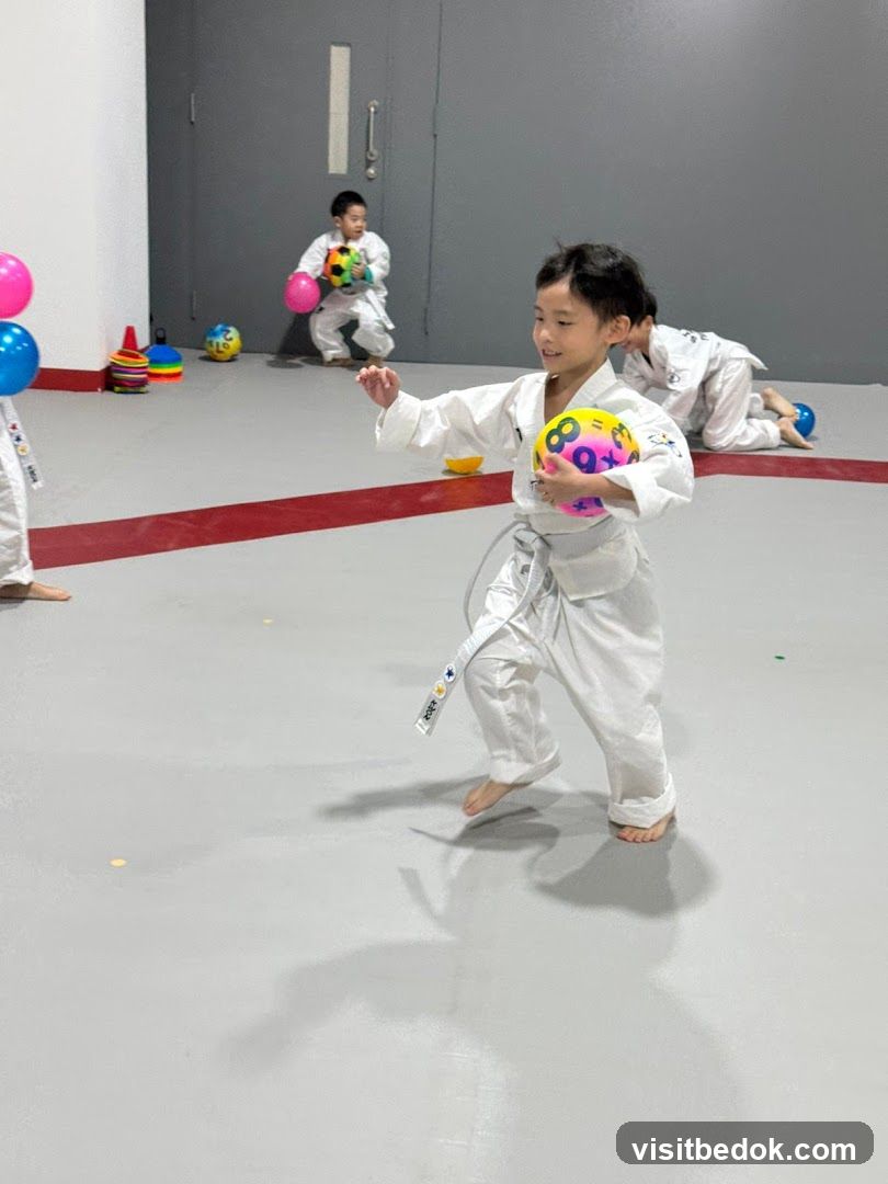 Children in Taekwondo Uniforms Playing with Balls