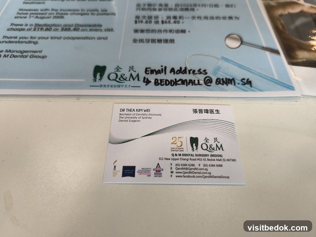 Q&M Dental Group Business Card and Information Sheet