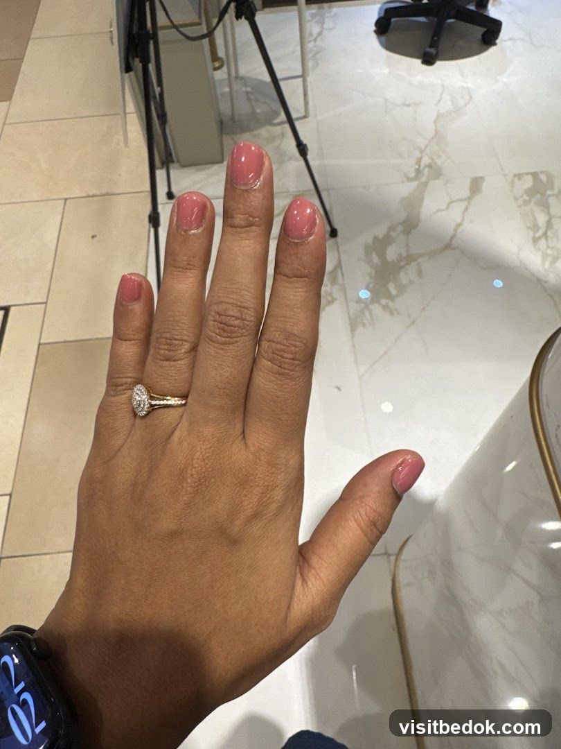 Woman's Hand with Pink Nail Polish and Ring
