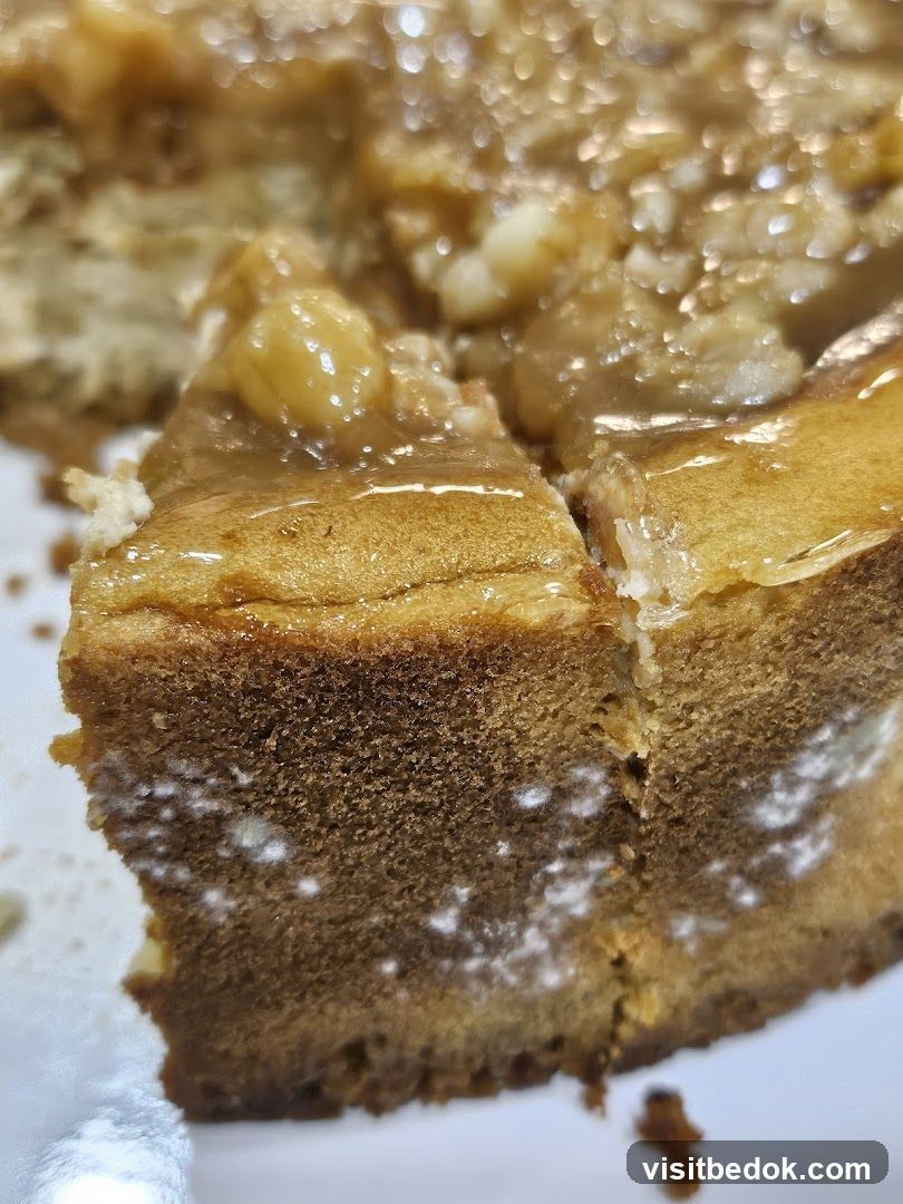 Close-up of a slice of cake with caramel and nuts