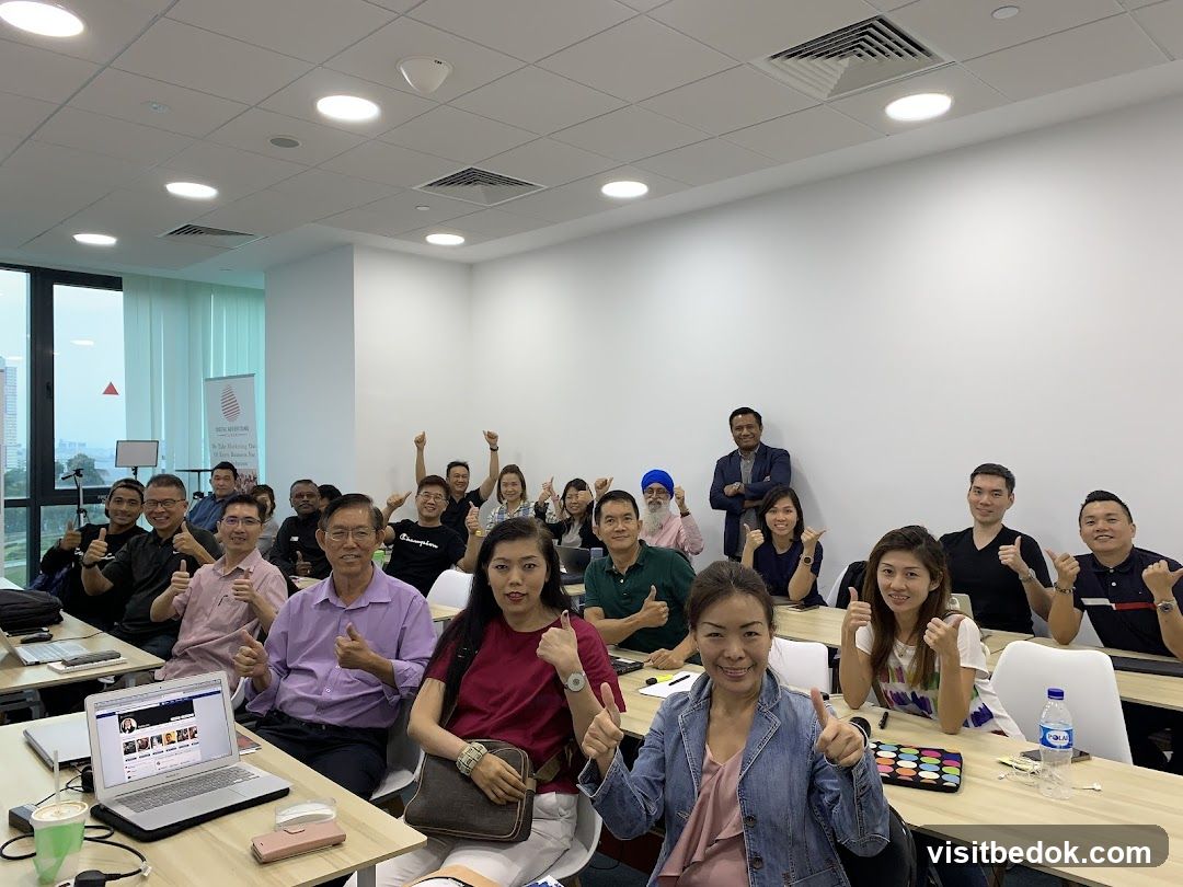 People in a classroom giving thumbs up