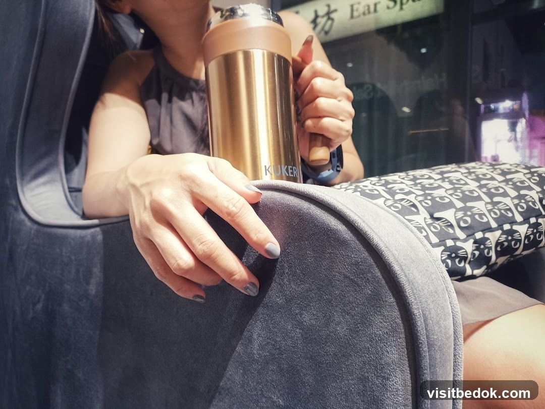 Woman holding a thermos in a lounge chair