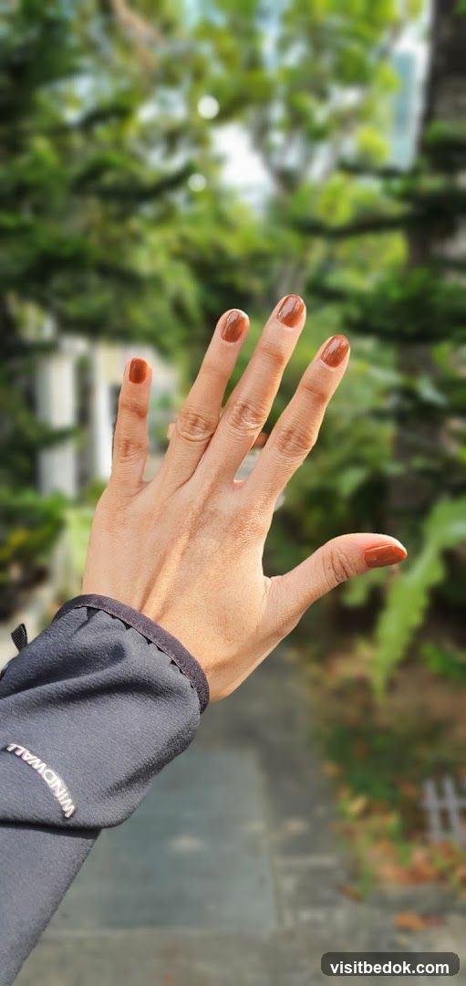 Hand with Brown Nail Polish