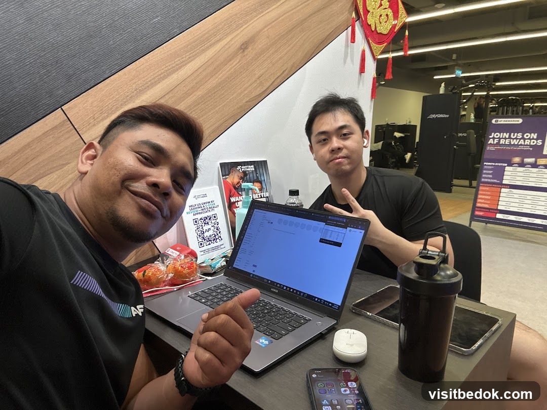 Two men at a desk in a gym