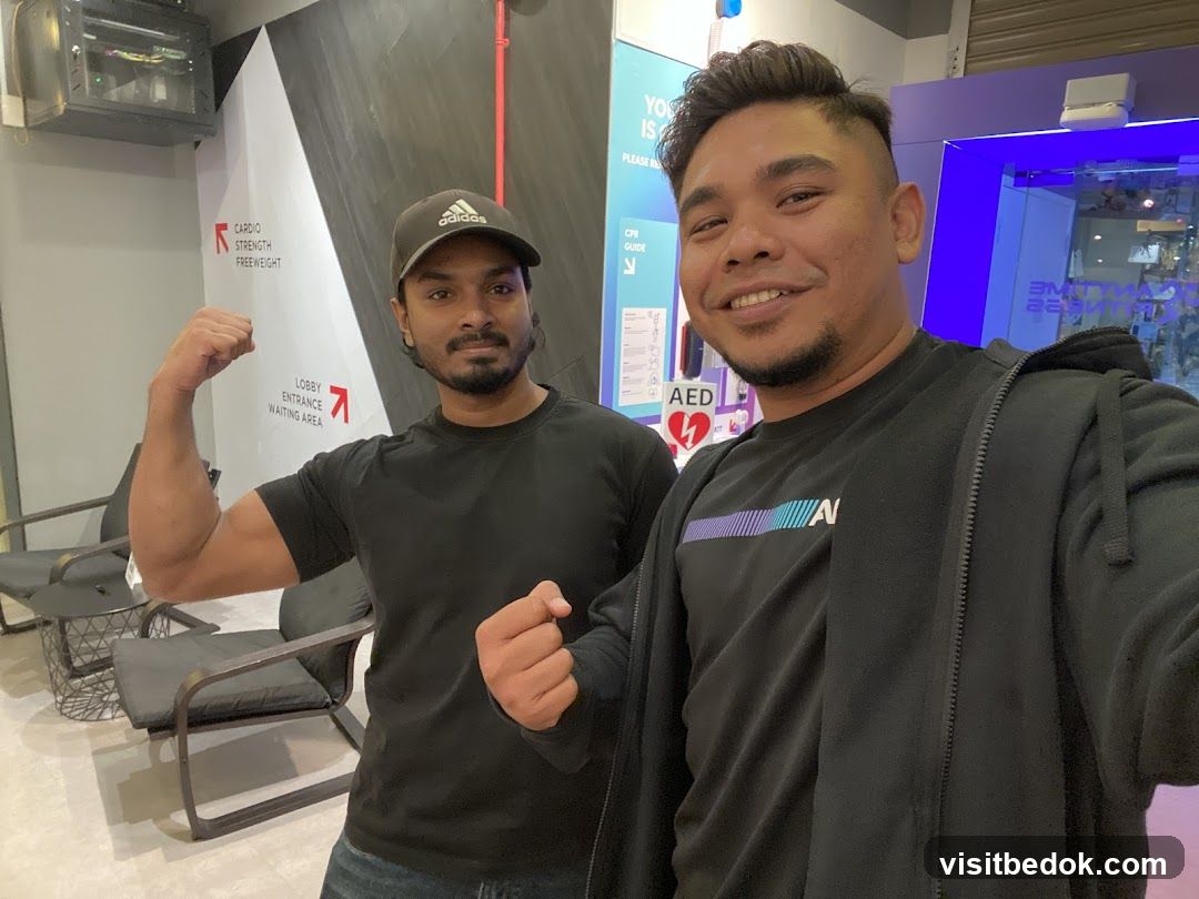 Two men posing in a gym