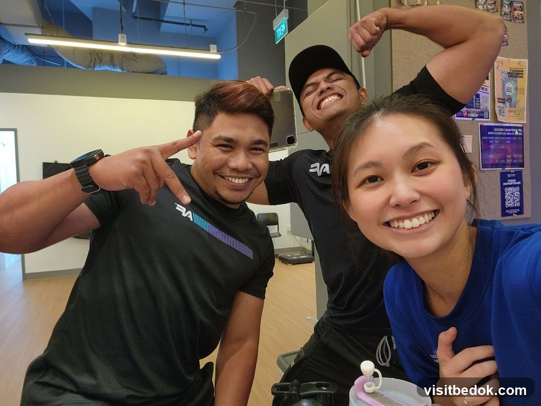 Three people smiling in a gym