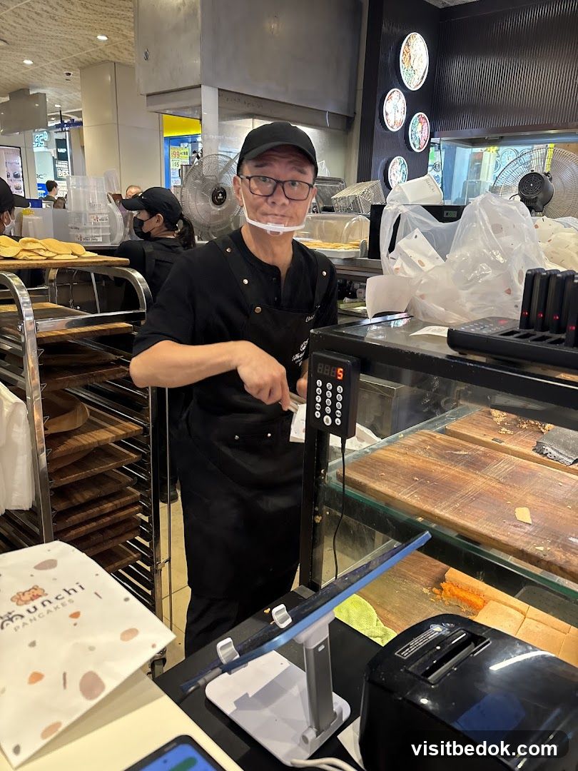 Staff member at a food counter