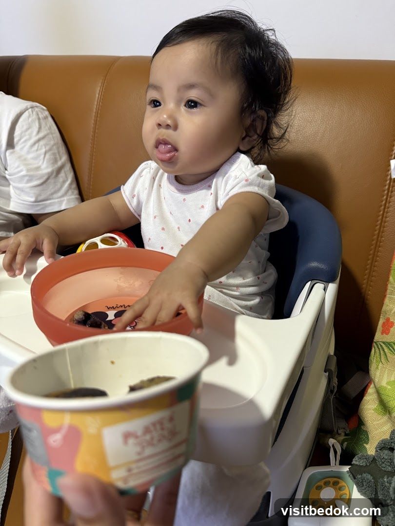 Baby eating from a cup