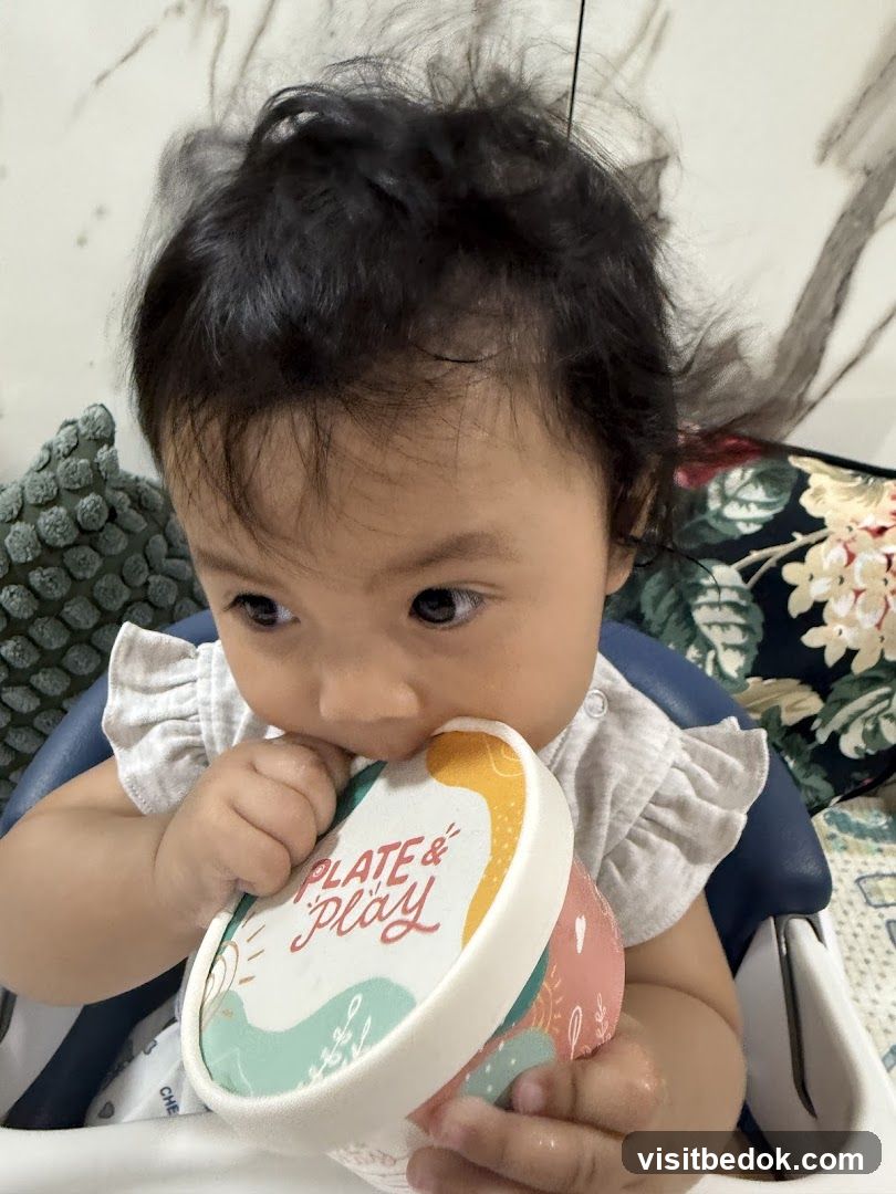 Baby with a container