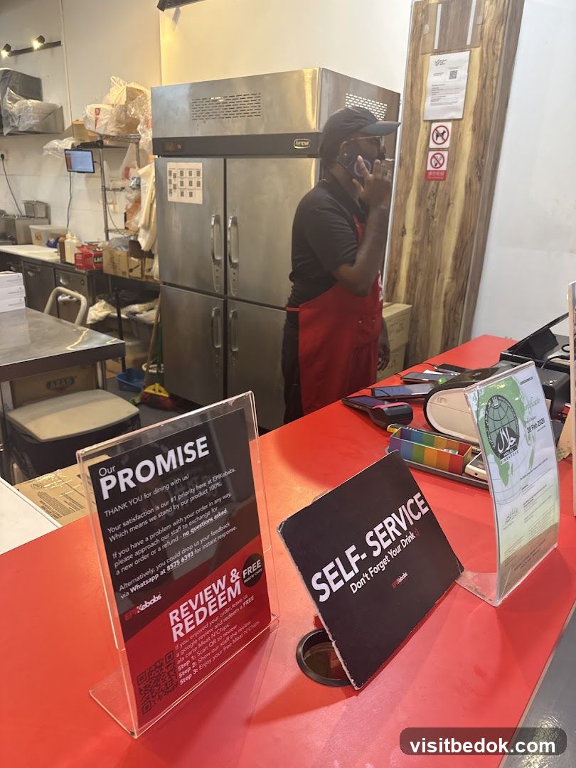 Restaurant Counter with Staff and Promotional Signs