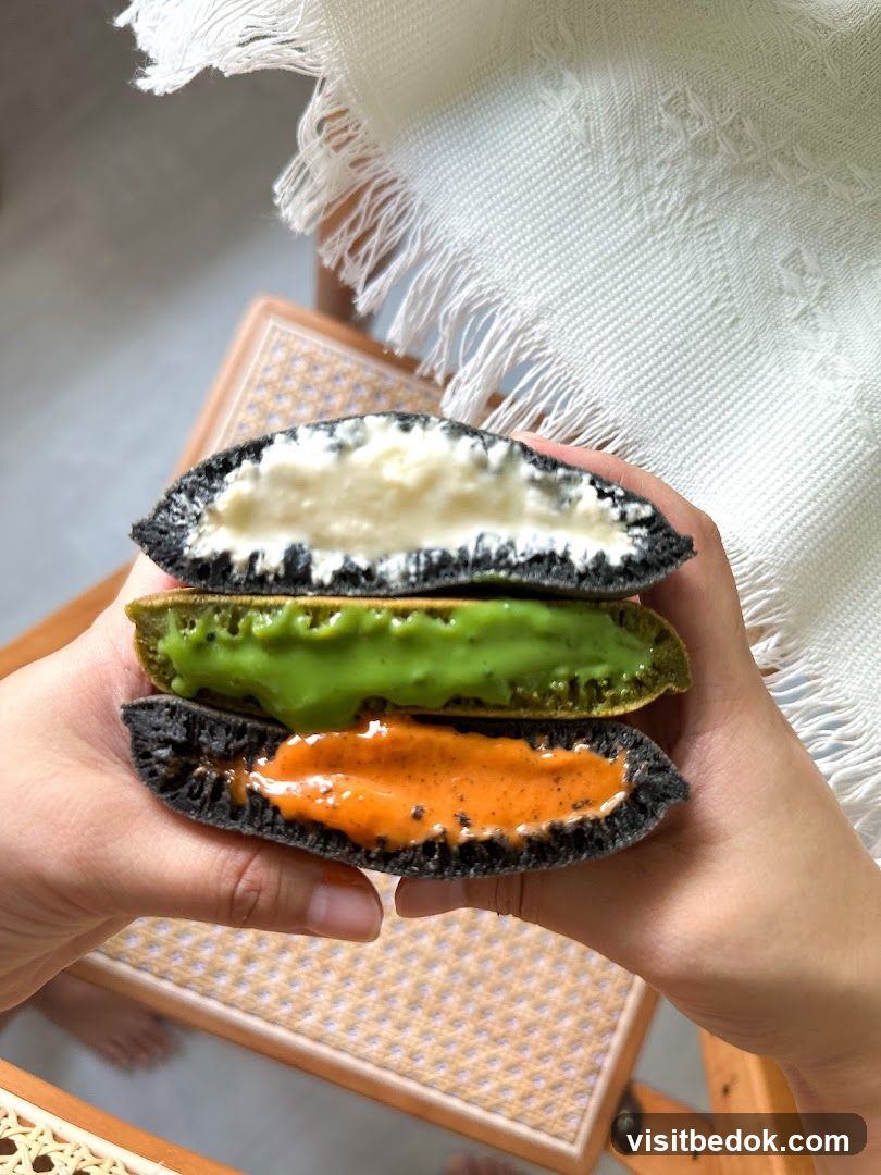 Three layered dessert held by hands